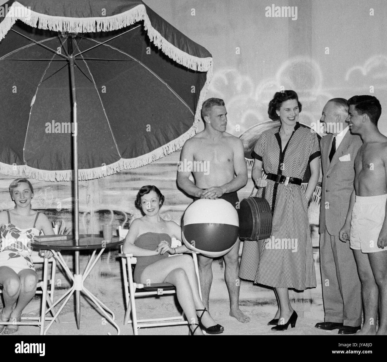Dr Maurice Sullivan (second from right), guest, and cast on set for 'Beware of the Sun' segment of the Johns Hopkins Science Review television show, May, 1951. Stock Photo