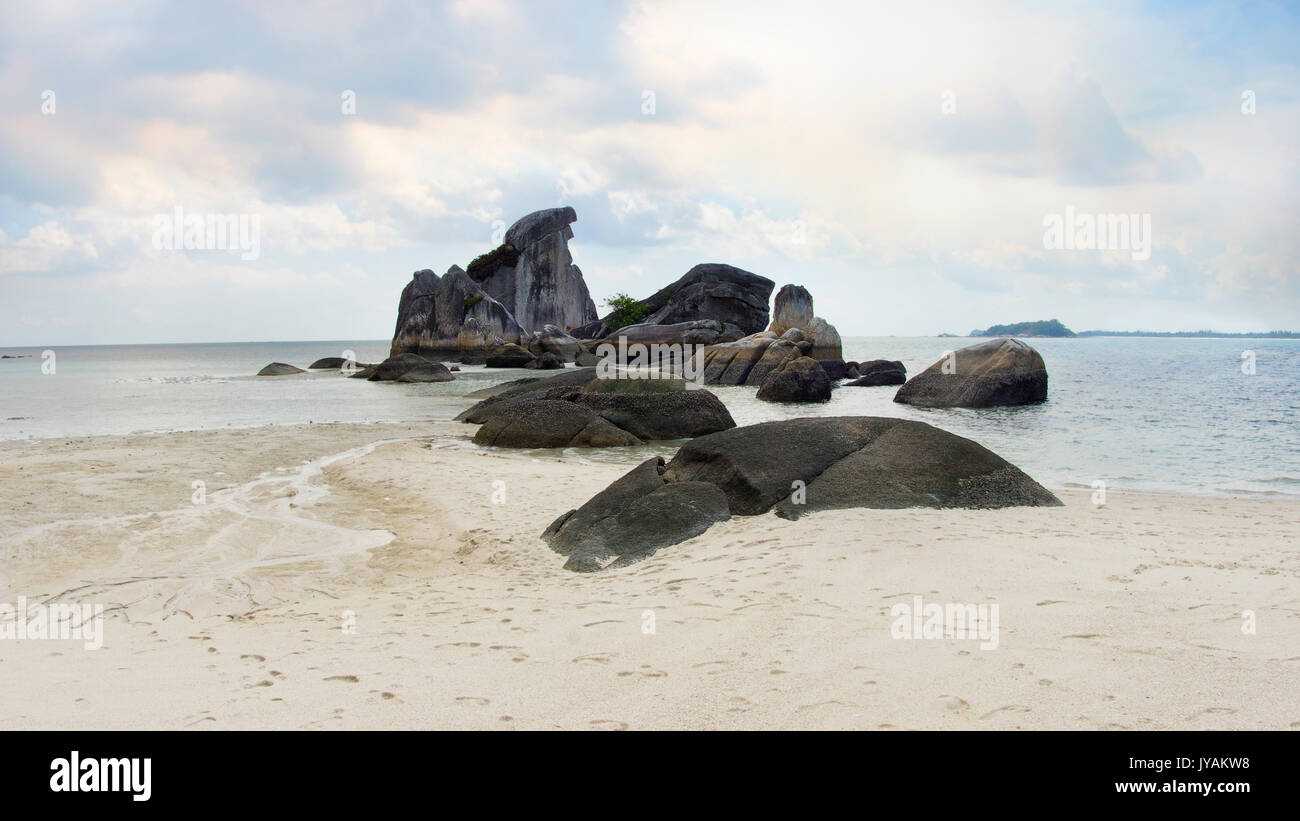 Natural rock formation in the sea and on a white sand beach in Belitung Island in the morning, Indonesia. Stock Photo
