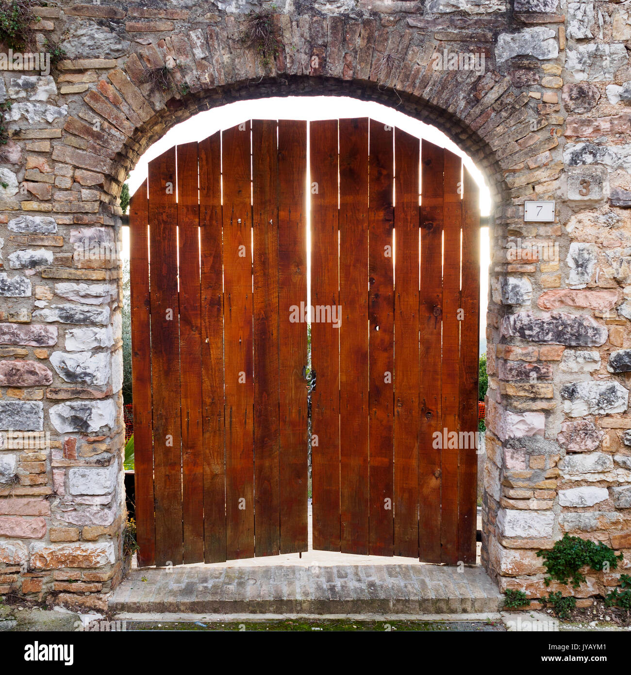 Old wooden door in Spello (Italy), 2017. Squared format. Stock Photo