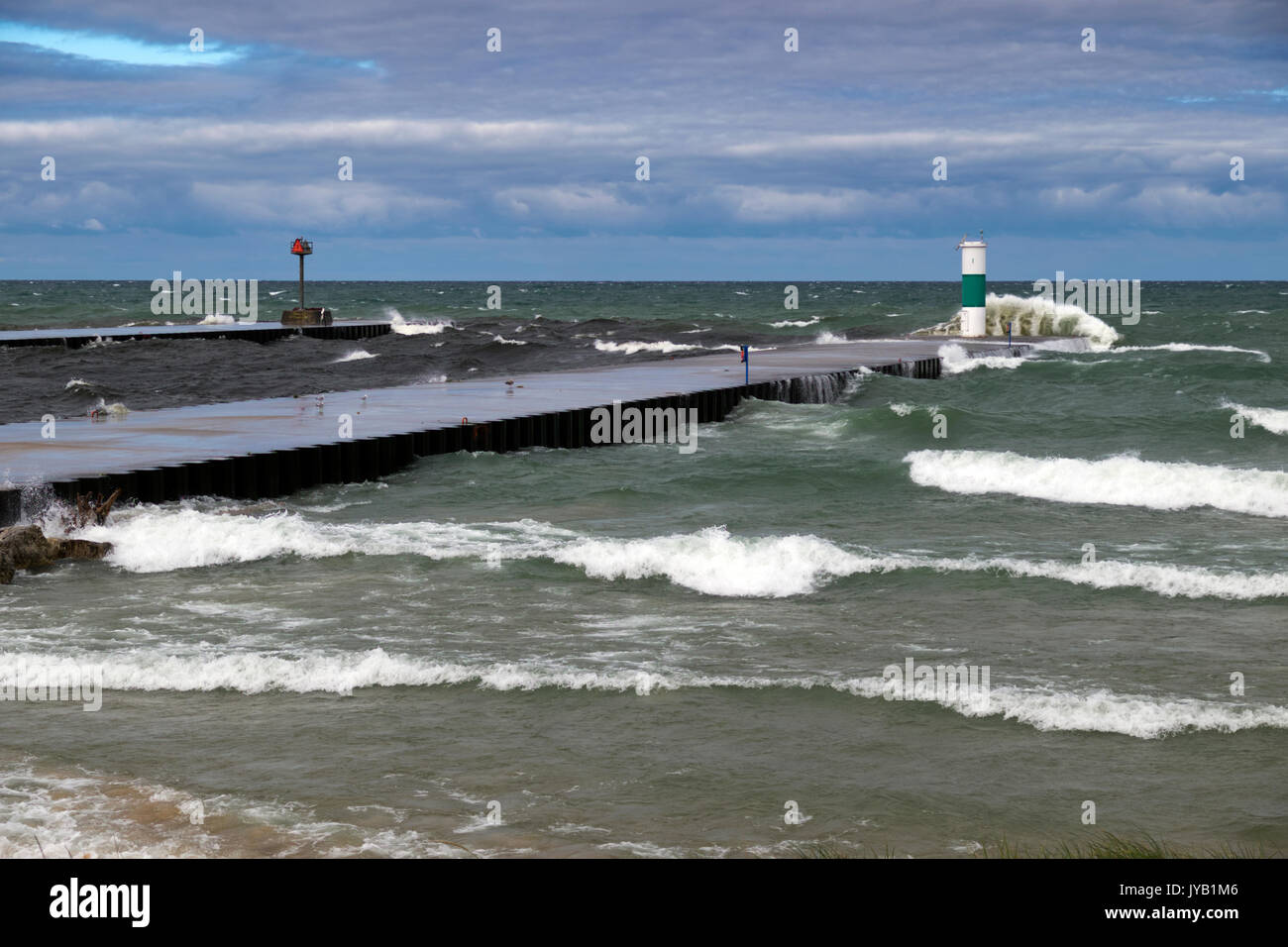Piersr and navigation lights at the White Lake Channel taking a pounding from 6 and 7 foot waves rolling in from Lake Michigan. Stock Photo