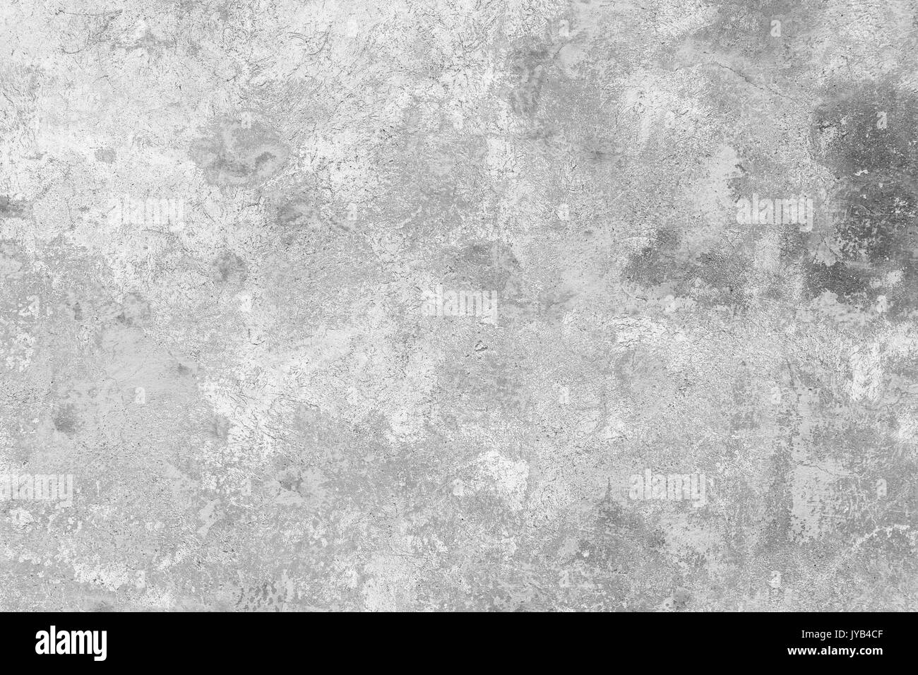 Close-up of a weathered and aged concrete wall, paint partly peeled off. Texture background in black and white. Stock Photo