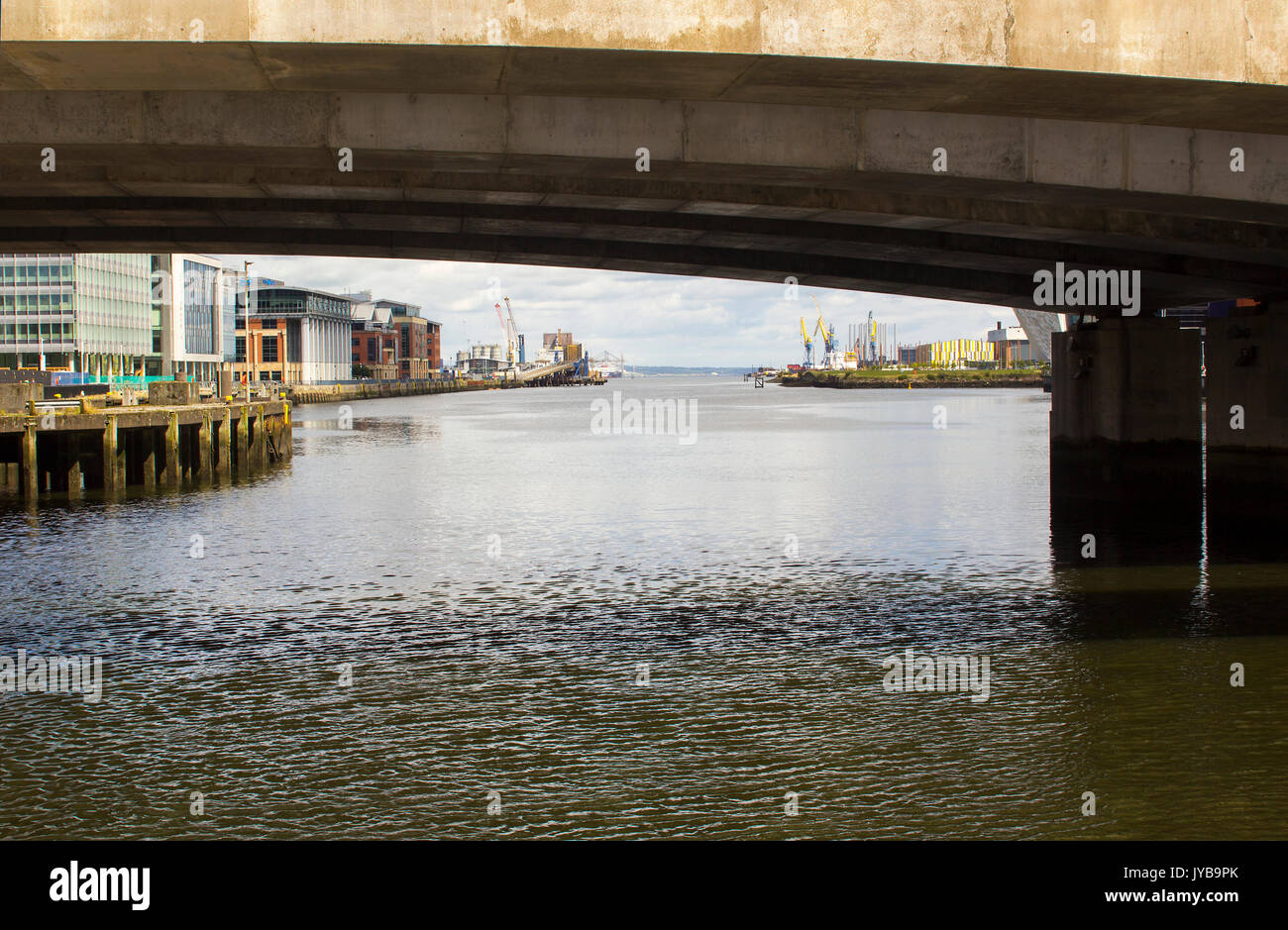 A view down the Belfast lough toward the Irish sea through one of the arches of the Dargan Railway Bridge in Belfast Northern Ireland Stock Photo