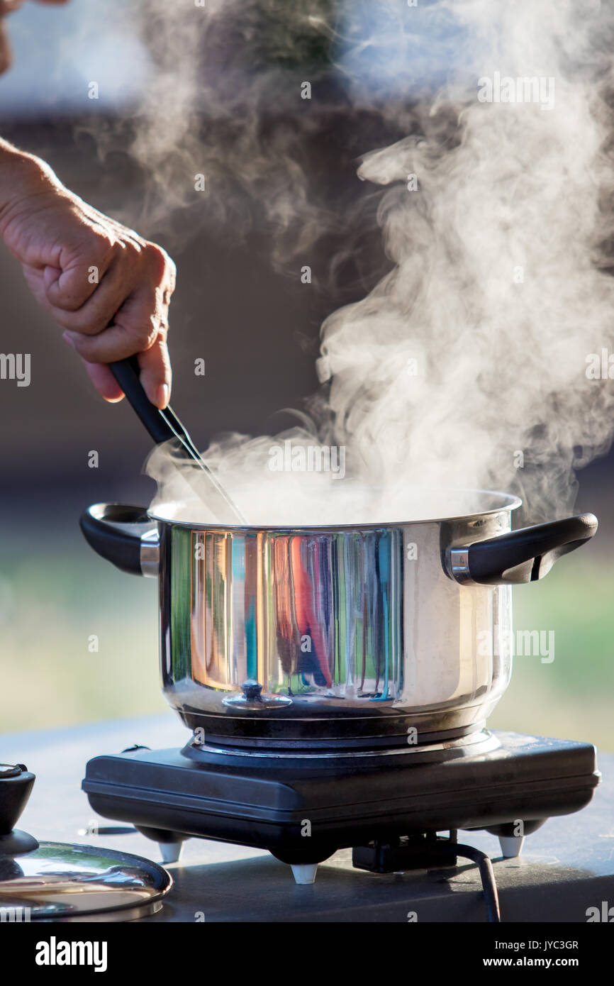 hand cooking on hot pot with water steam Stock Photo - Alamy
