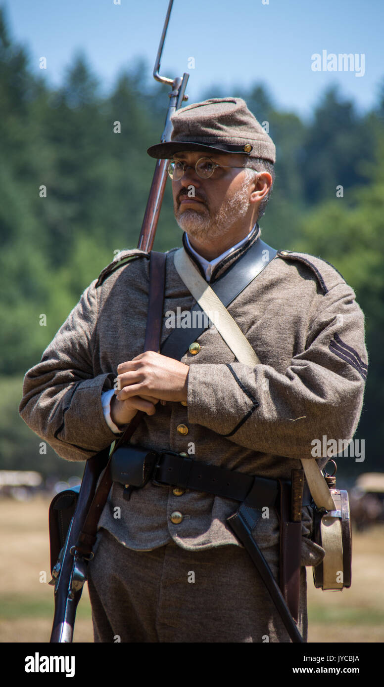 Man stands in Confederate uniform during Civil War Reenactment at Duncan Mills on July 14, 2014 Stock Photo