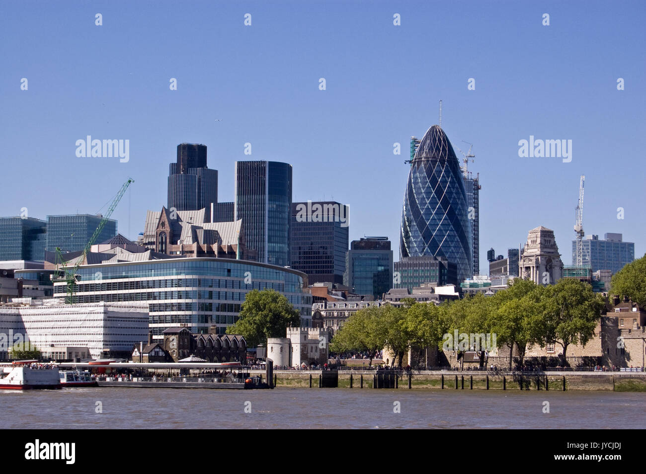 View across the River Thames looking towards the City of London with famour skyscrapers including Tower 42 and The Gherkin. The historic walls of the  Stock Photo