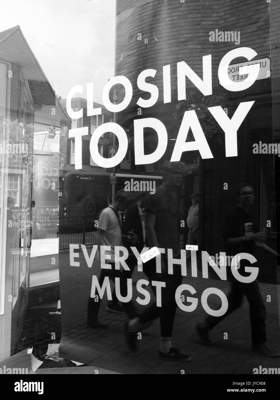 Closing today everything must go and sale posters in retail shop window Stock Photo