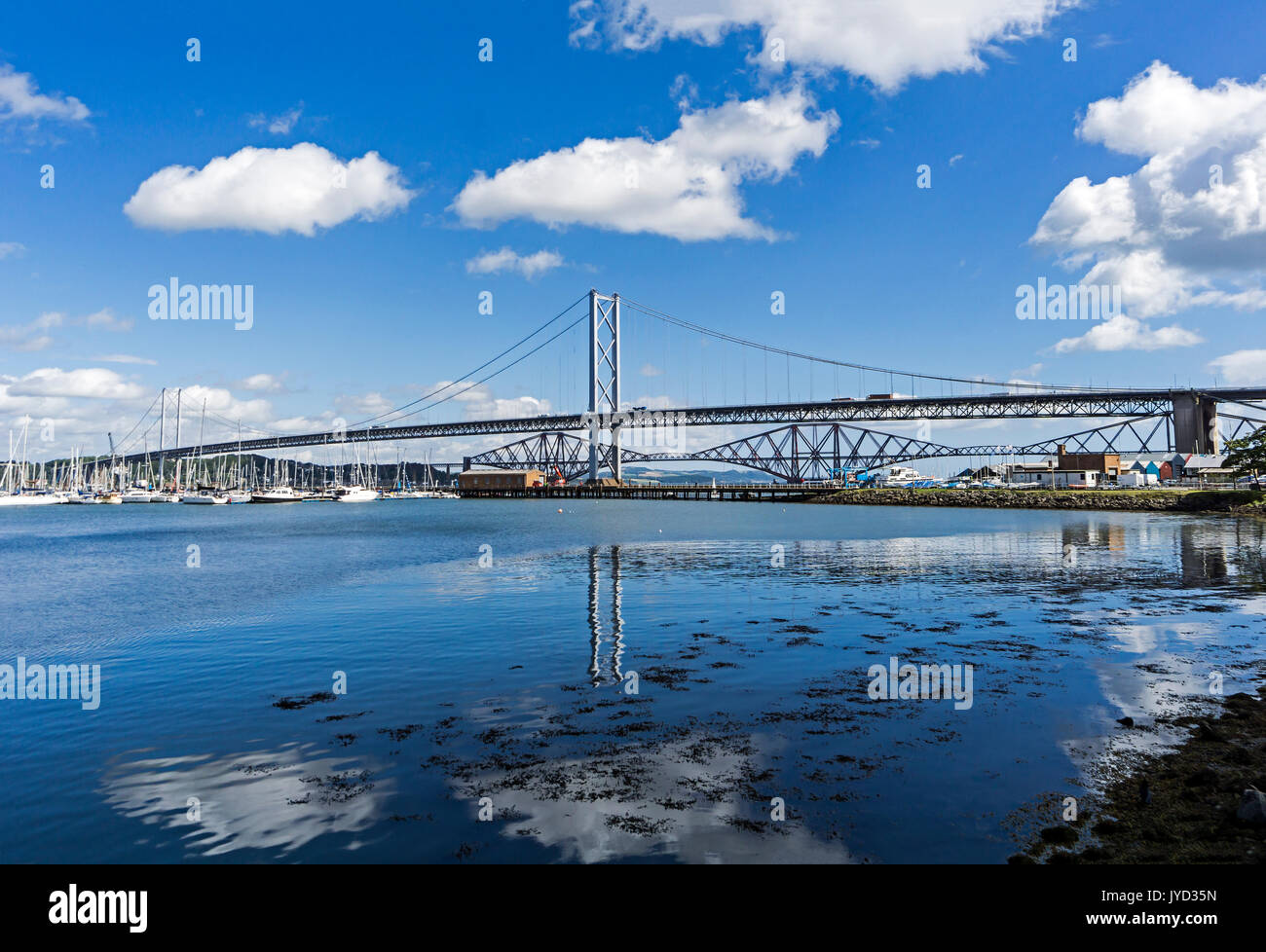 The old Forth Road Bridge and Forth Bridge behind seen from Port Edgar in South Queensferry west of Edinburgh Scotland UK Stock Photo