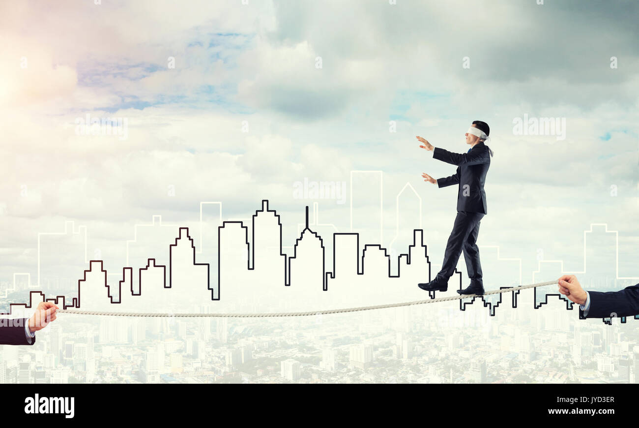 Business concept of risk support and assistance with man balancing on ...
