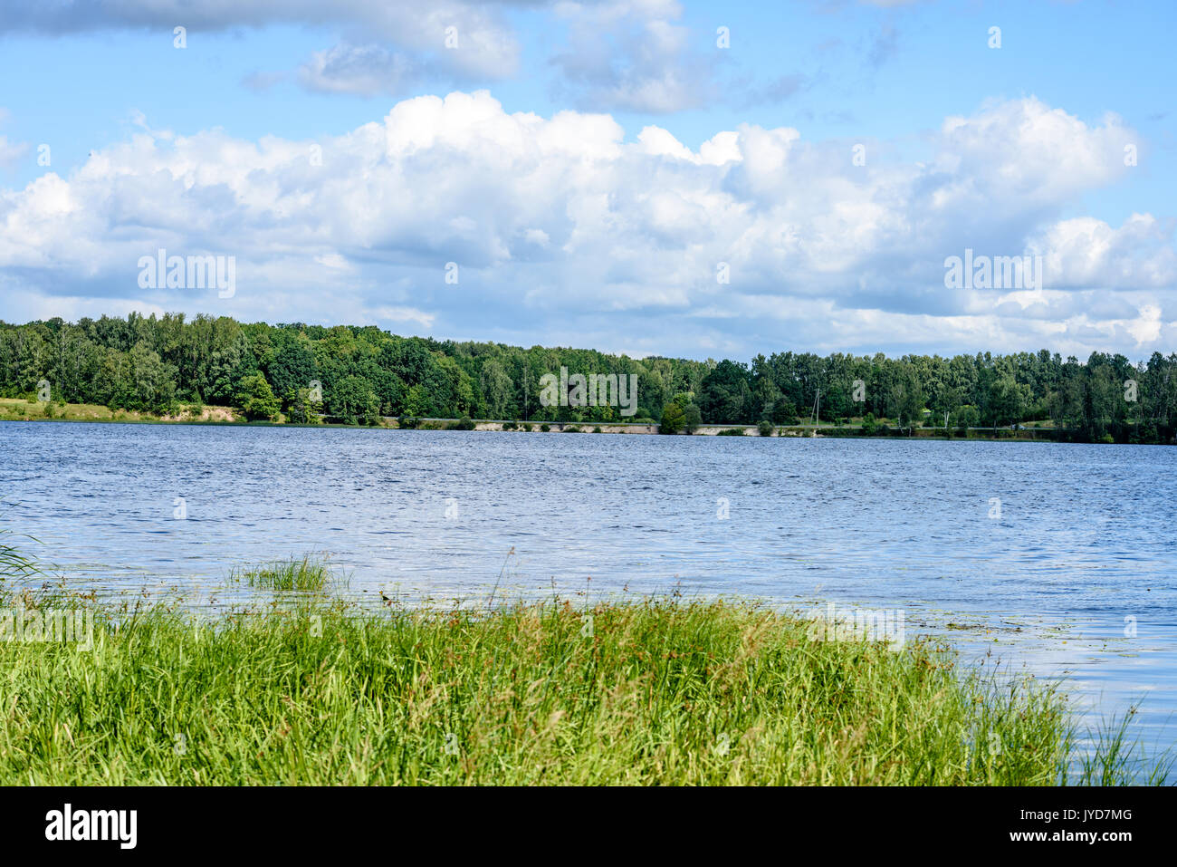 colorful clouds over the lake in summer with reflection of blue sky and ...