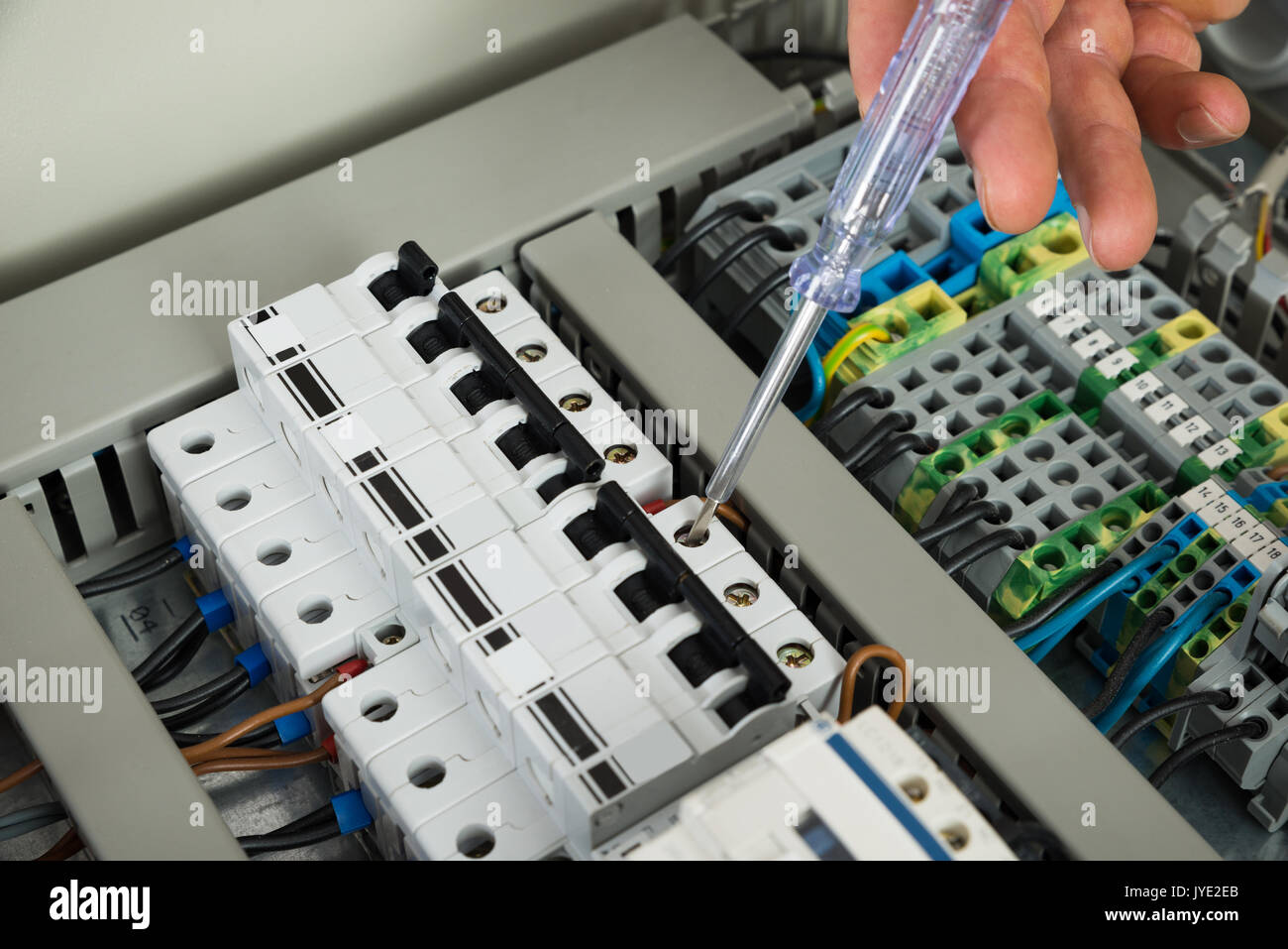 Close-up Of A Male Technician Repairing Fusebox Stock Photo