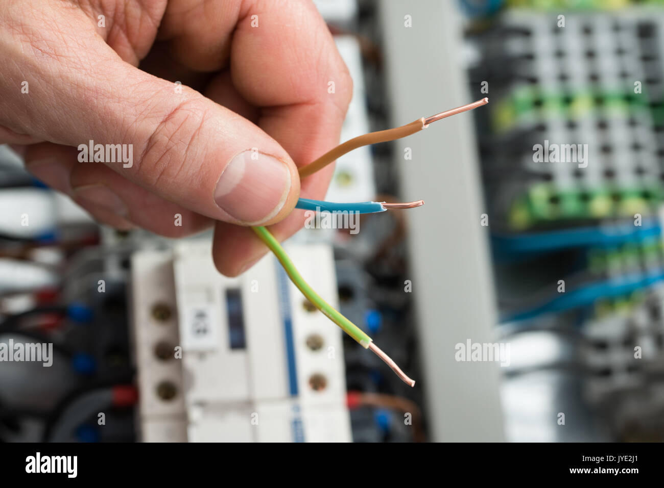 Close-up Of A Person's Hand Holding Cables Stock Photo