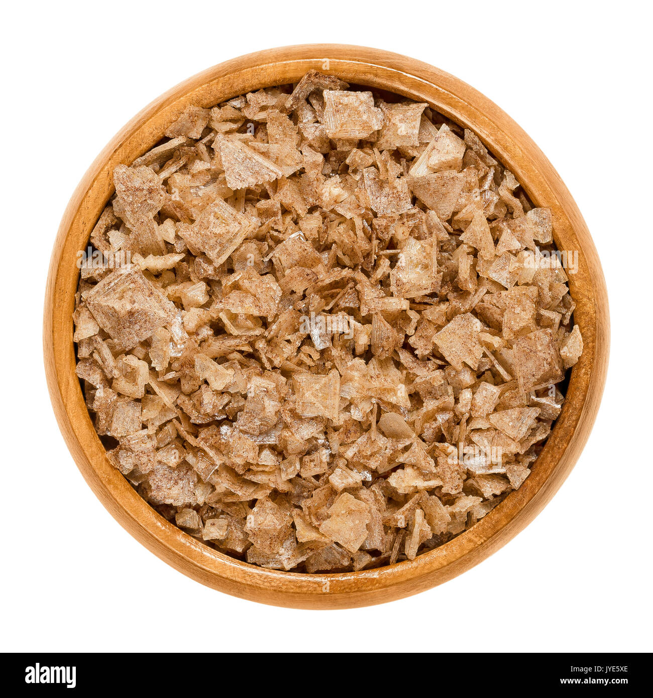 Smoked pyramid shaped sea salt in wooden bowl. Aromatic brown handmade flake salt from Cyprus with hollow pyramidal shaped crystals. Seasoning. Stock Photo