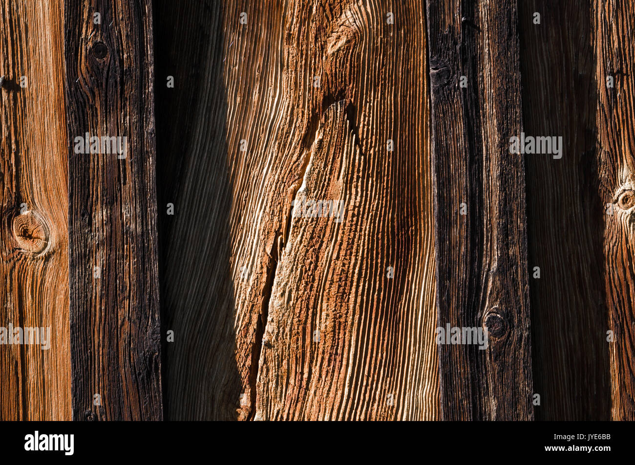 The texture, fresh dark wooden boards are arranged vertically