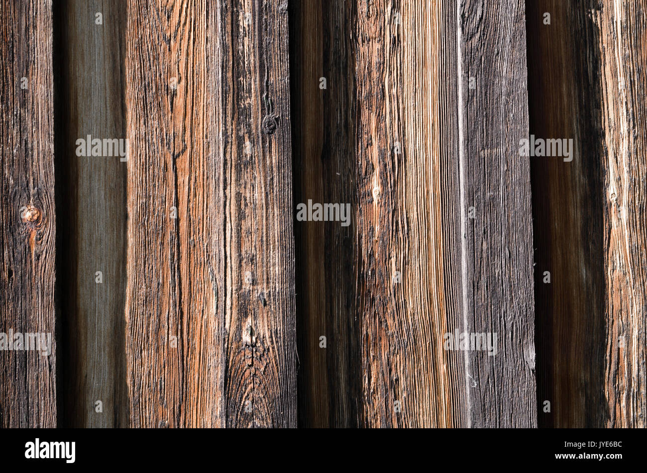 The texture, wooden dark brown brown boards are arranged vertically