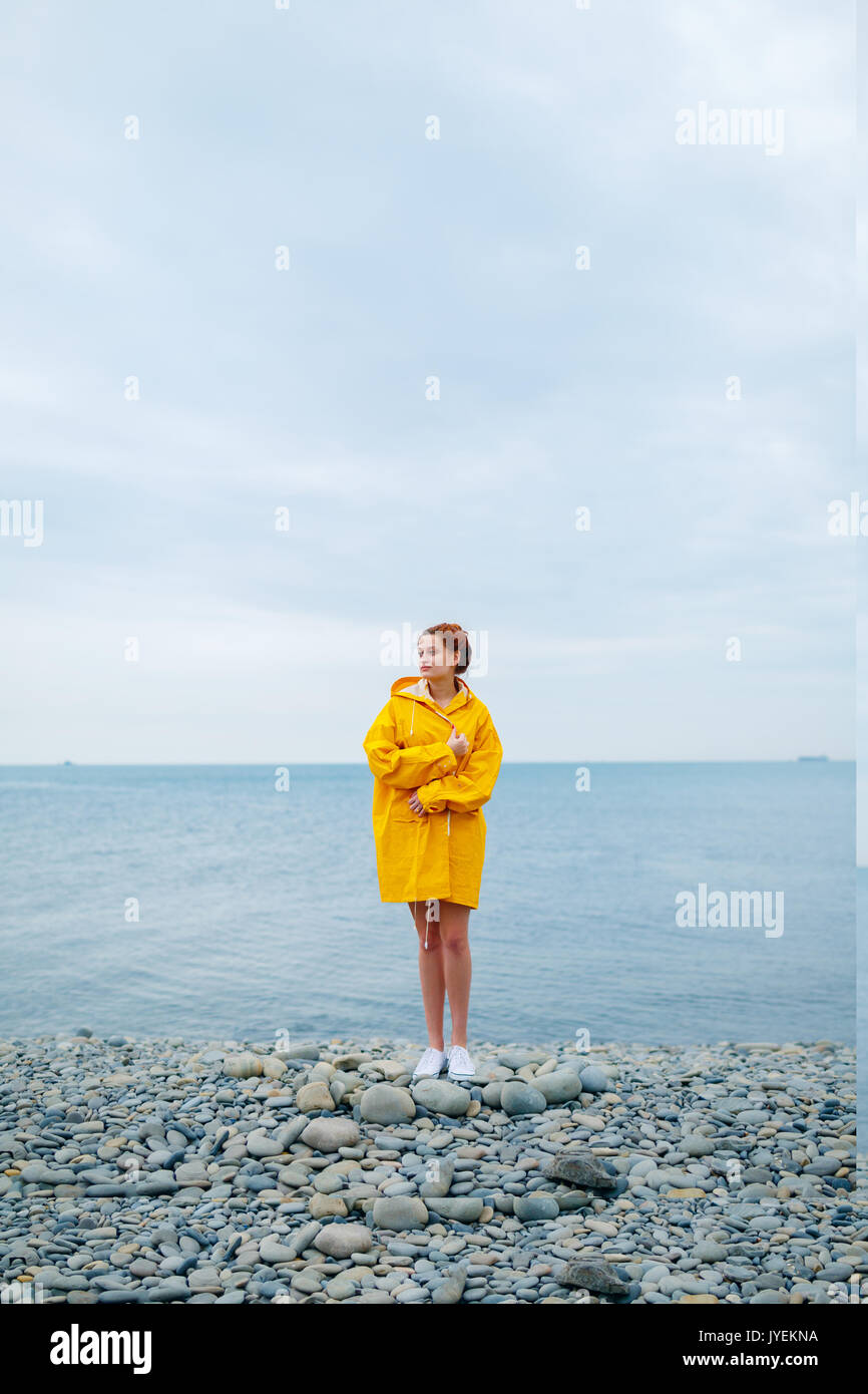 Girl wearing yellow raincoat hi-res stock photography and images - Alamy