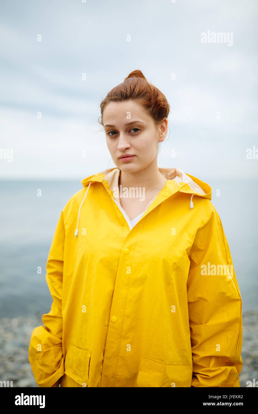 Girl wearing yellow raincoat Stock Photo Alamy