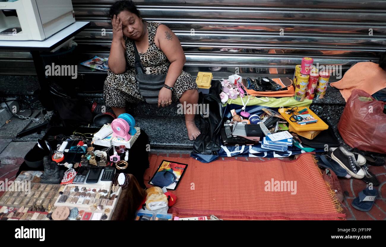 Exhausted street seller Lady Chinatown Bangkok Street Vendors commerce buy and sell out on the street poor people Stock Photo