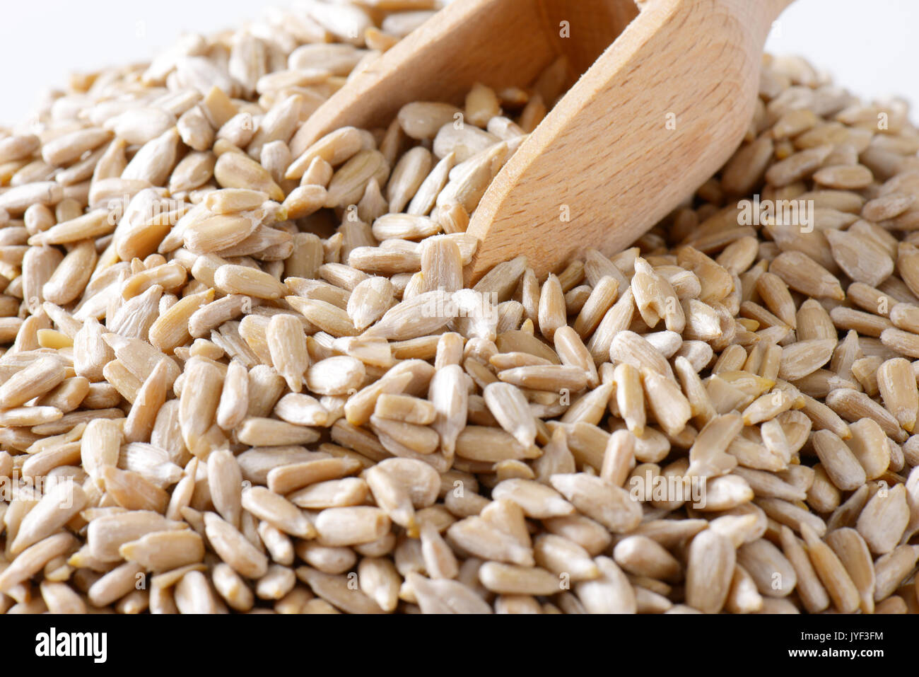 Heap of raw sunflower seeds and scoop Stock Photo