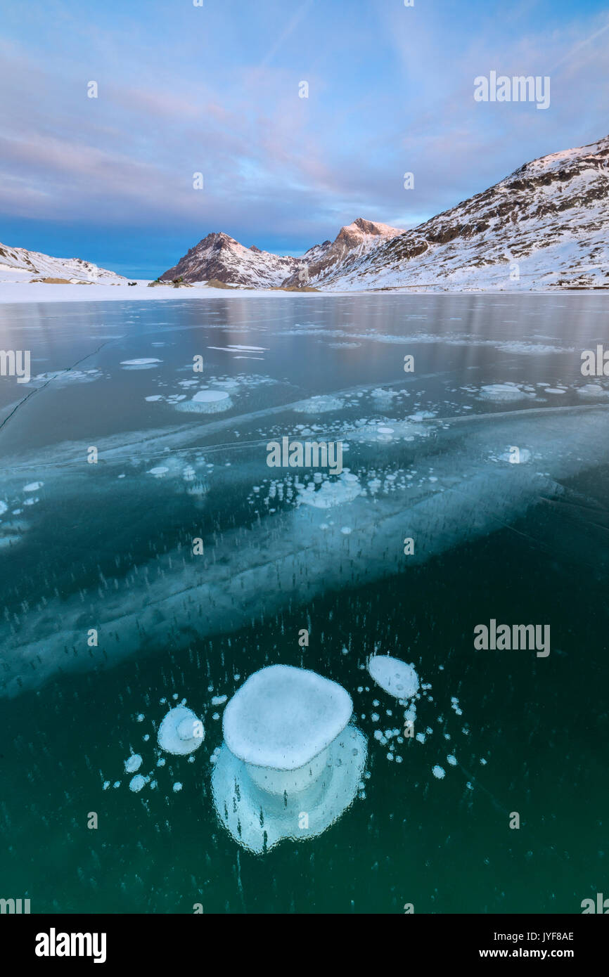 Ice Bubbles Frame The Snowy Peaks Reflected In Lago Bianco Bernina Pass Canton Of Graubunden Engadine Switzerland Europe Stock Photo Alamy
