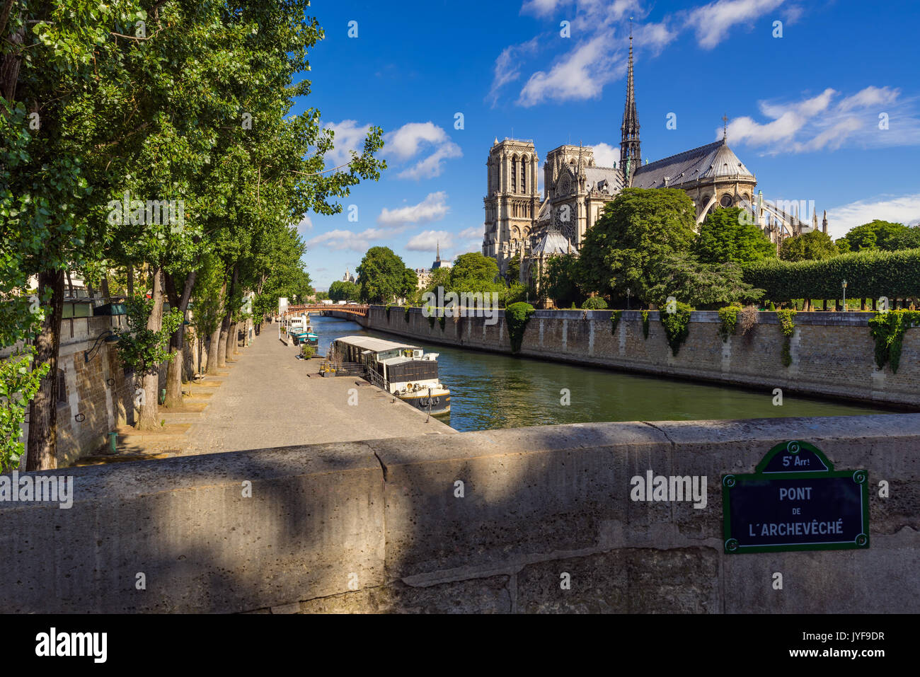 Notre Dame de Paris cathedral on Ile de La Cite with the Seine River in summer. Pont de l'Archeveche, Paris, France Stock Photo