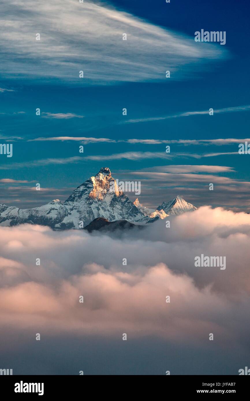 The massive Matterhorn emerging out of the clouds at sunrise. Next to it, another majestic peak, the Weisshorn - from one of the peak in the Mont Avic Stock Photo