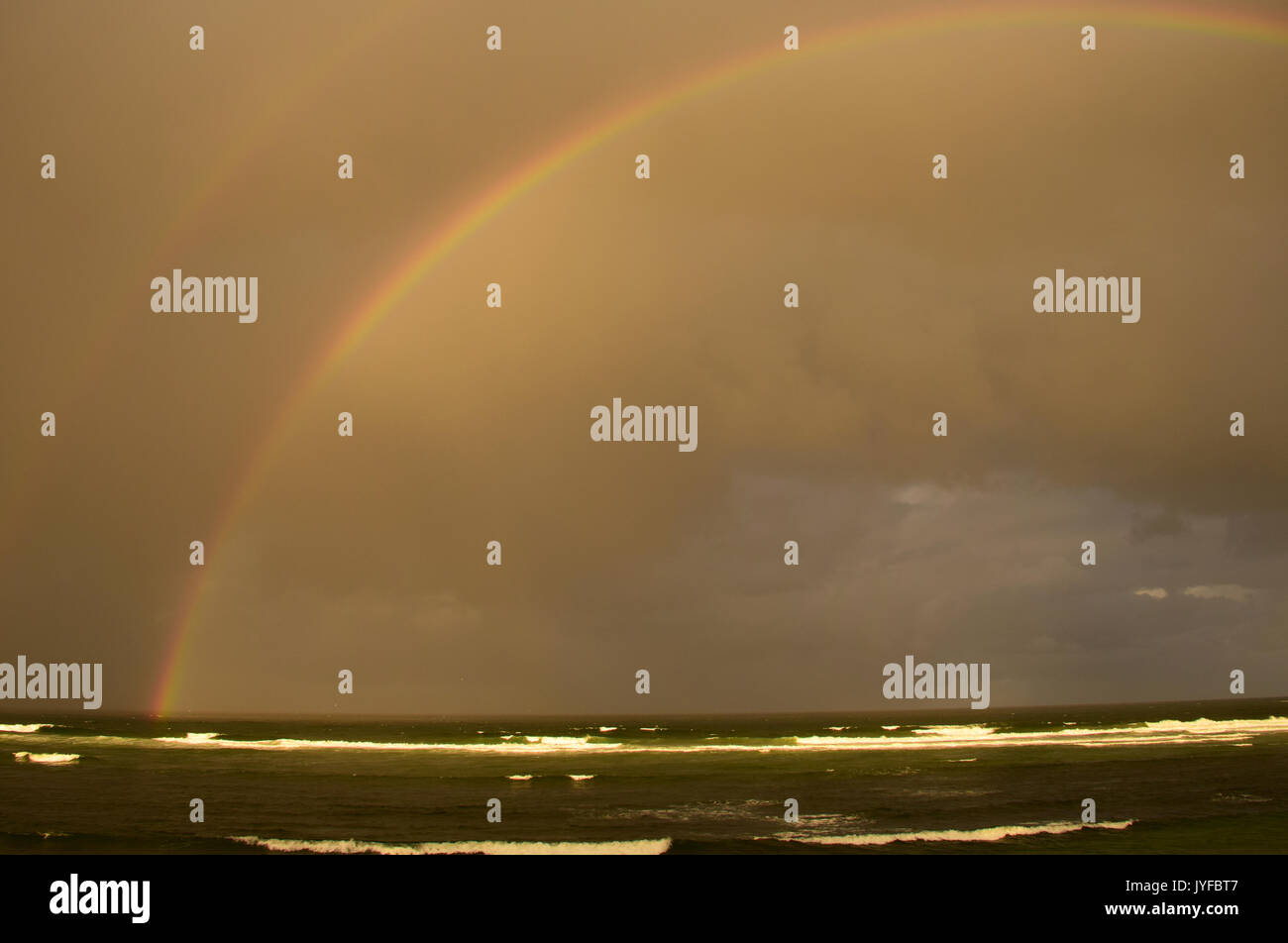 Rainbow over the Sea, Seven Mile Beach, New South Wales, Australia Stock Photo