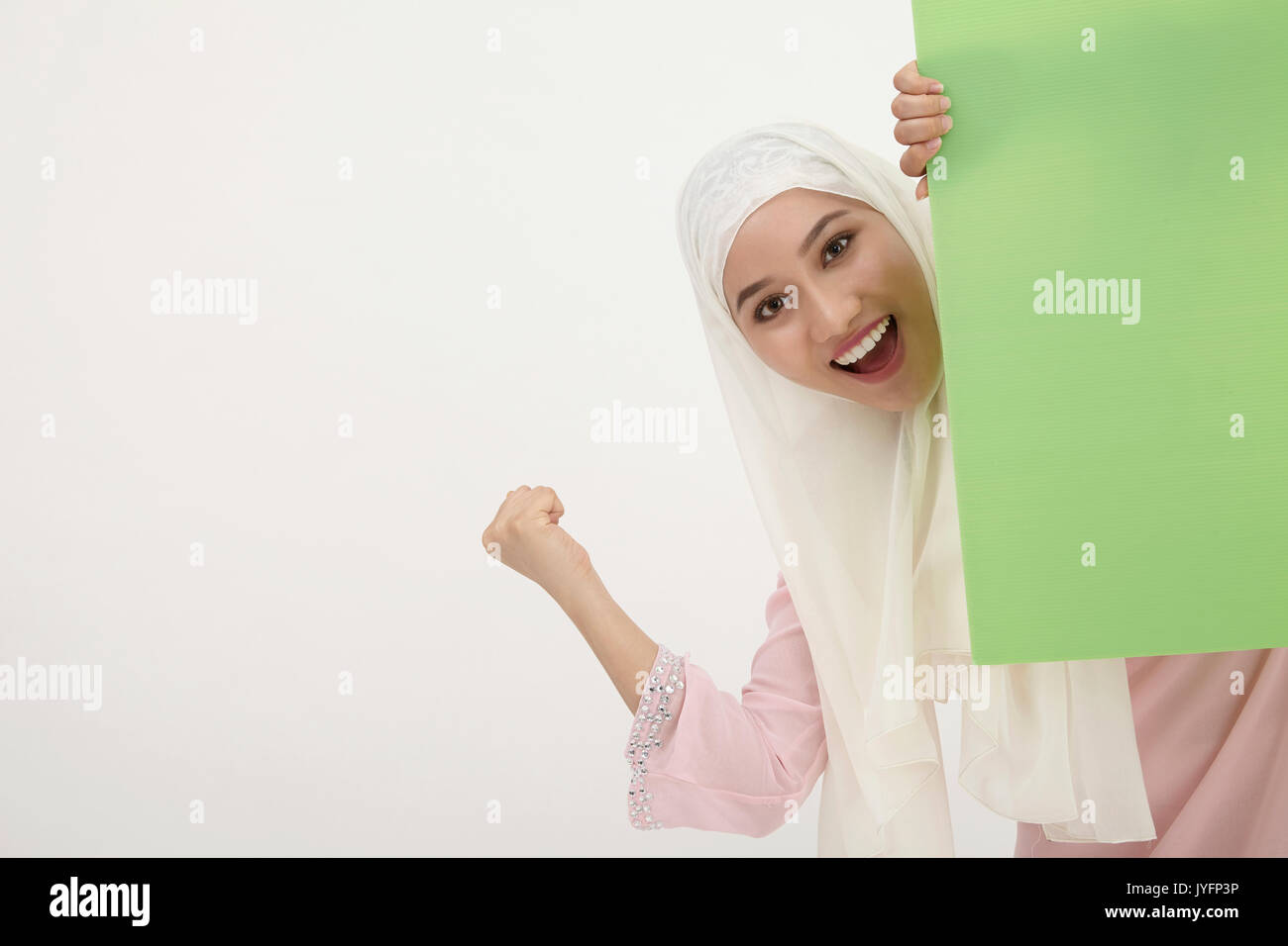 malay woman with tudung,behind of the green placard Stock Photo Alamy