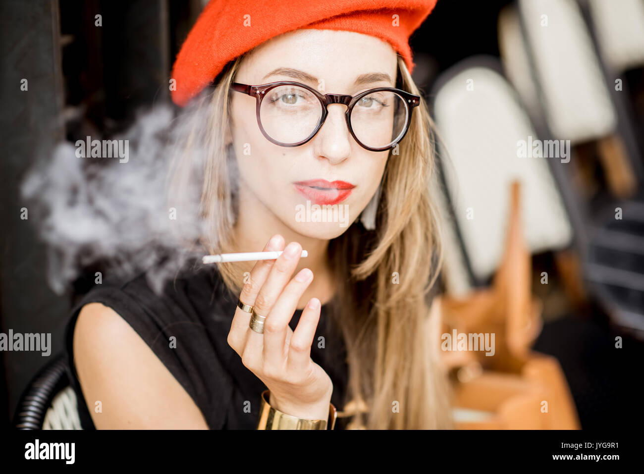 French woman smoking at the cafe Stock Photo