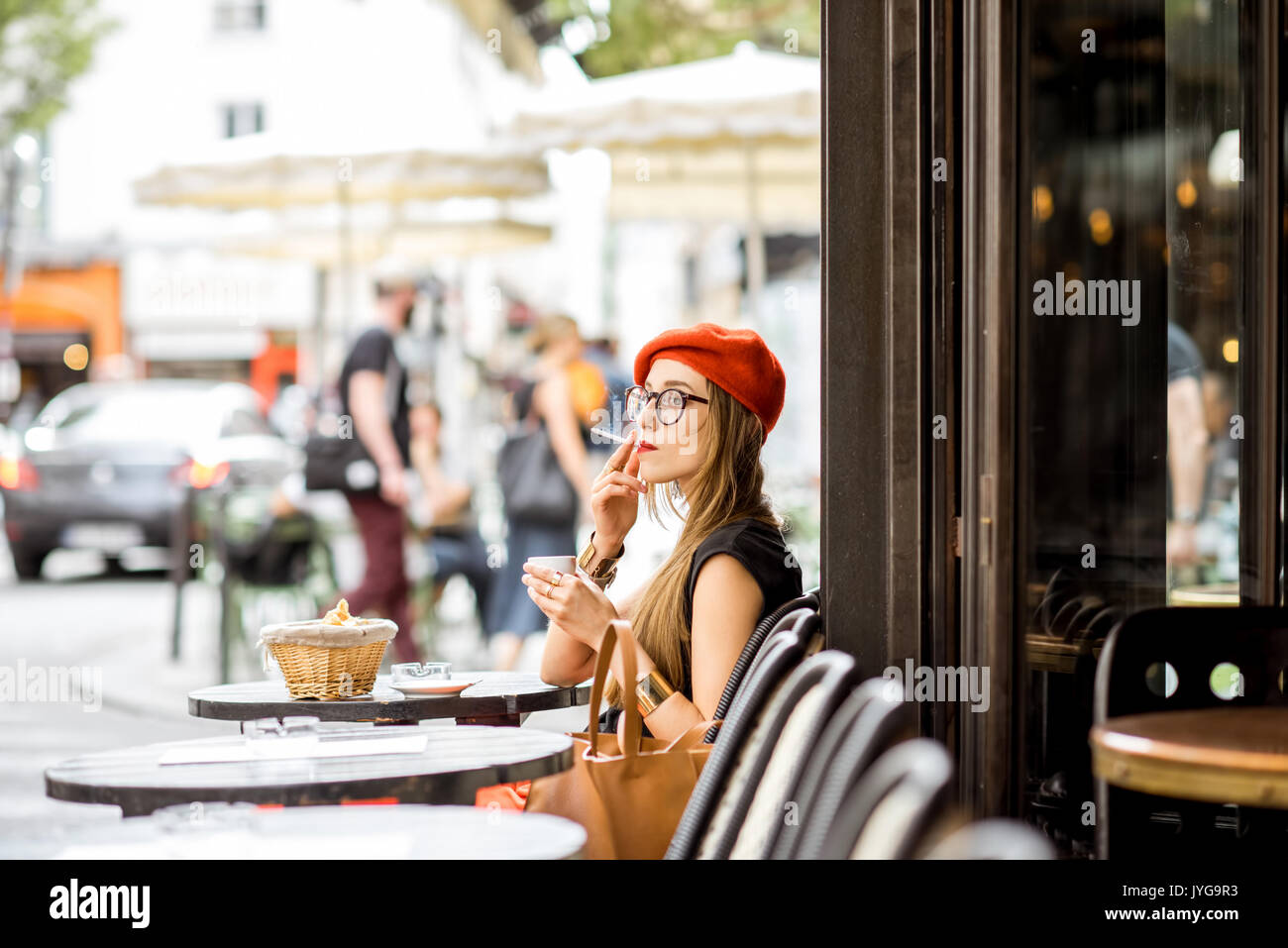 French woman smoking at the cafe Stock Photo