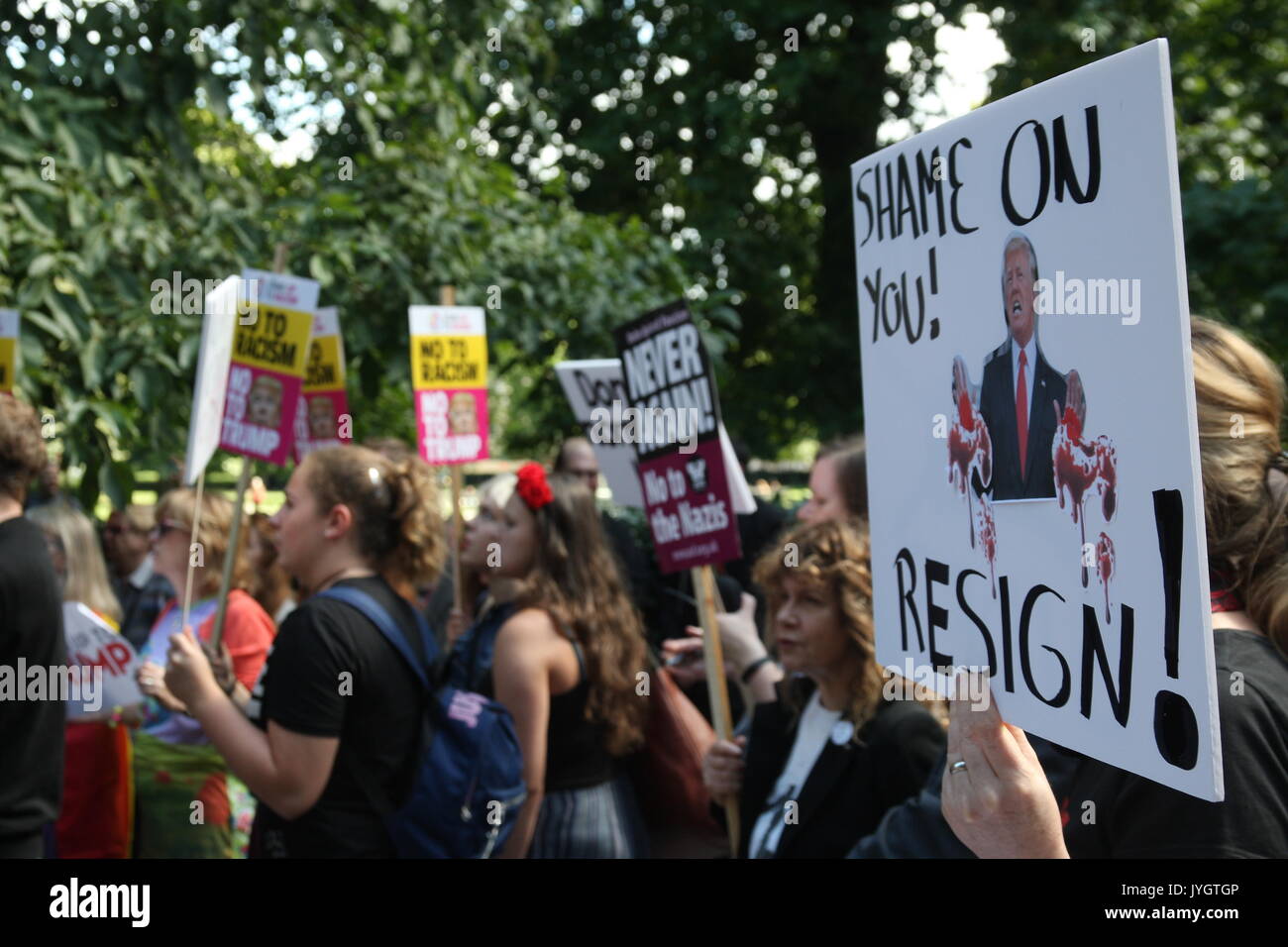 London, UK, 19th August 2017.  A protest against Donald Trump's recent statements against Korea and about events in Charlottesville takes place outside the US embassy in London.  A sign is held showing Trump and the slogan 'Shame on You! Resign!' Roland Ravenhill/Alamy Live News. Stock Photo