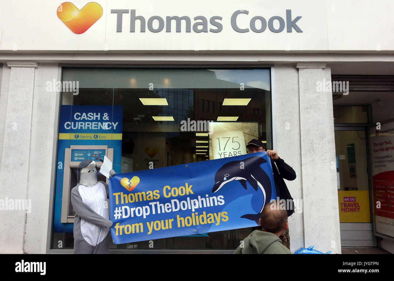 London, UK. 19th August, 2017.  Activists from Dolphin Freedom UK protest outside branch of Thomas Cook travel agents in Islington against 'cruel dolphin shows in Mexico and Caribbean'. The campaign claim that 'swim with dolphins' activities causes suffering to the sea animals. Please credit pictures by Jeffrey Blackler/Alamy Live News Stock Photo