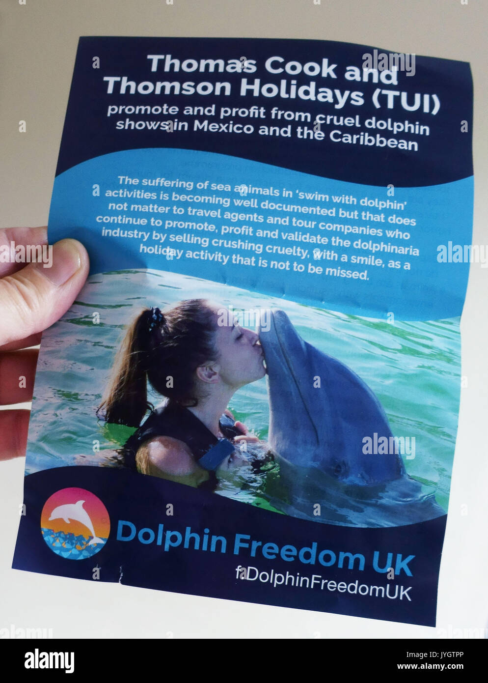 London, UK. 19th August, 2017.  Activists from Dolphin Freedom UK protest outside branch of Thomas Cook travel agents in Islington against 'cruel dolphin shows in Mexico and Caribbean'. The campaign claim that 'swim with dolphins' activities causes suffering to the sea animals. Please credit pictures by Jeffrey Blackler/Alamy Live News Stock Photo