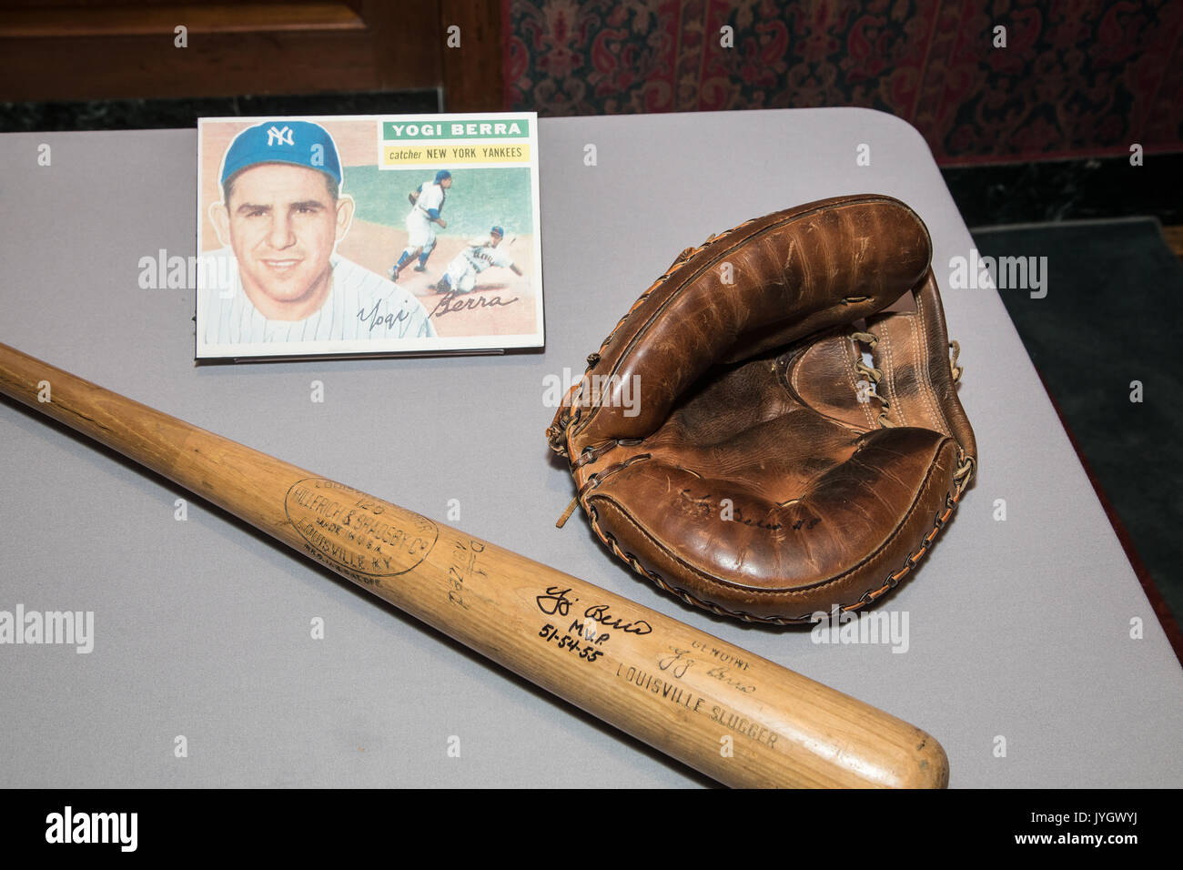 Baseball bat and glove used by Hall of Famer Yogi Berra in photo. In a
