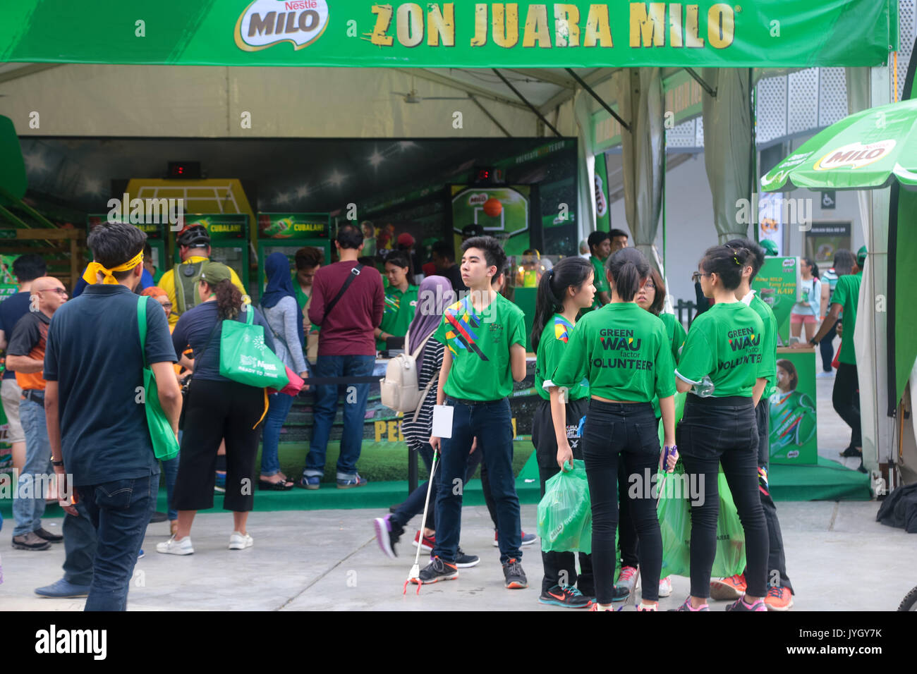 Green T-shirt volunteer are responsible for picking up trash on the day of opening ceremony of 29th SEA games. Credit: Calvin Chan/Alamy Live News Stock Photo
