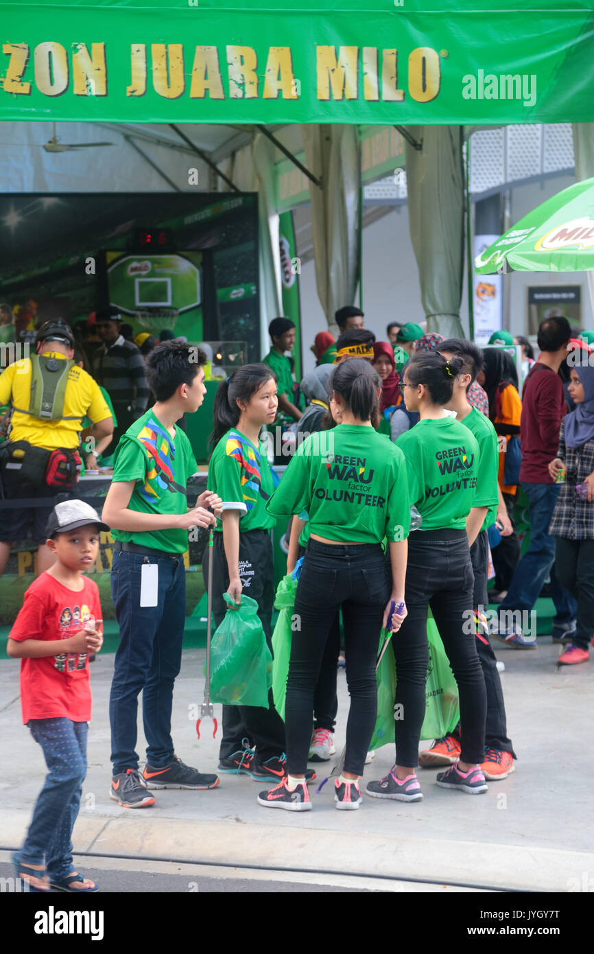 Green T-shirt volunteer are responsible for picking up trash on the day of opening ceremony of 29th SEA games. Credit: Calvin Chan/Alamy Live News Stock Photo