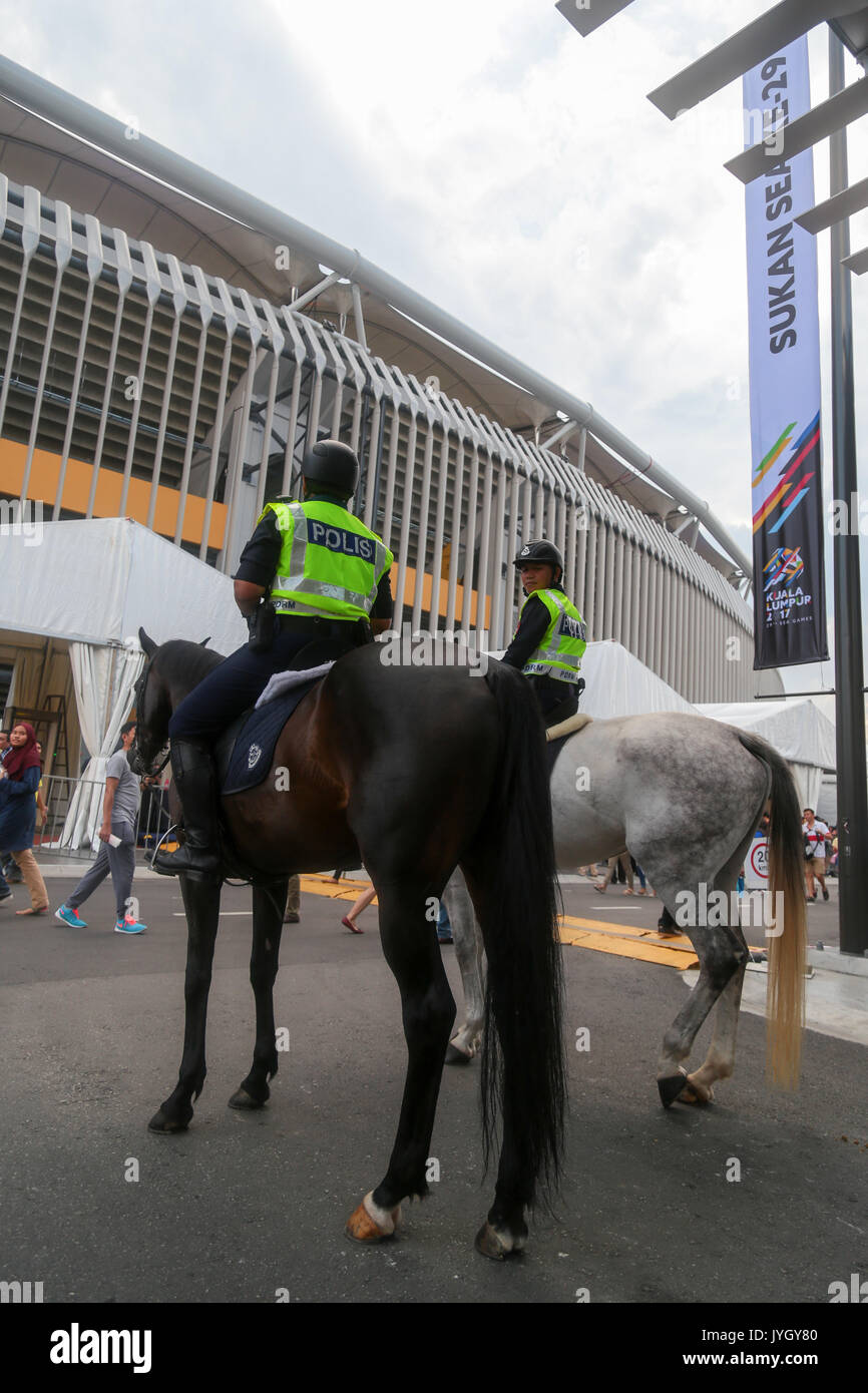Police personnels on horse back are observing security of the opening ceremony of 29th SEA games. Credit: Calvin Chan/Alamy Live News Stock Photo