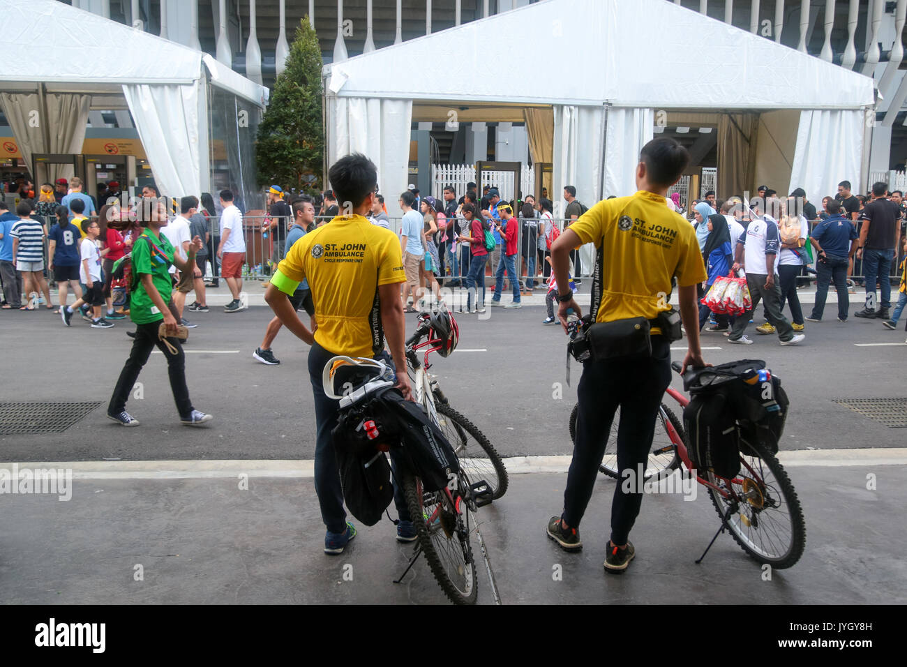St. John Ambulance personnels on bicycle on duty during the opening ceremony of 29th SEA games. Credit: Calvin Chan/Alamy Live News Stock Photo