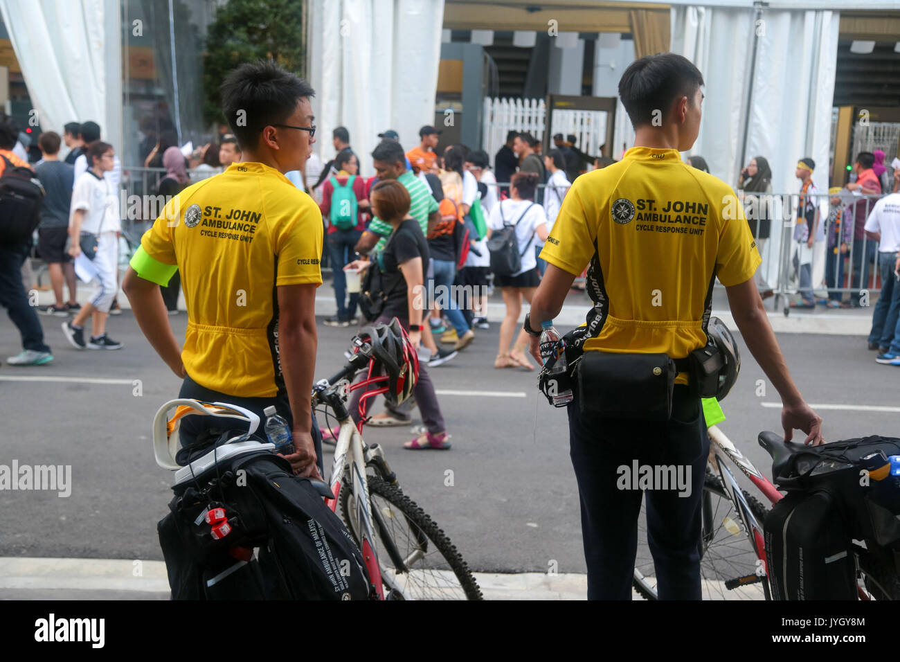 St. John Ambulance personnels on bicycle on duty during the opening ceremony of 29th SEA games. Credit: Calvin Chan/Alamy Live News Stock Photo