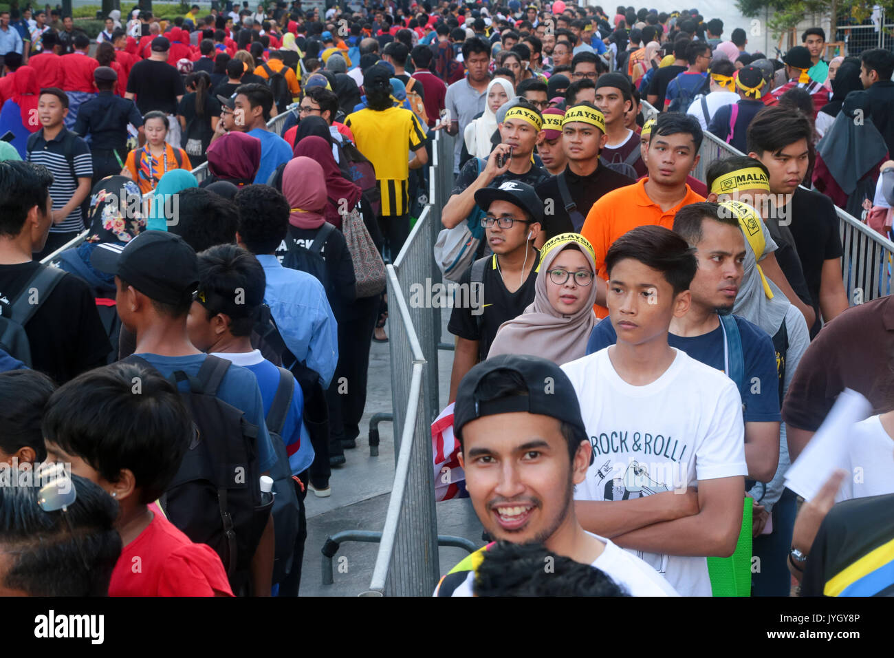 Cheerful crowd queue up to enter the national stadium to witness the opening ceremony of 29th SEA games. Credit: Calvin Chan/Alamy Live News Stock Photo