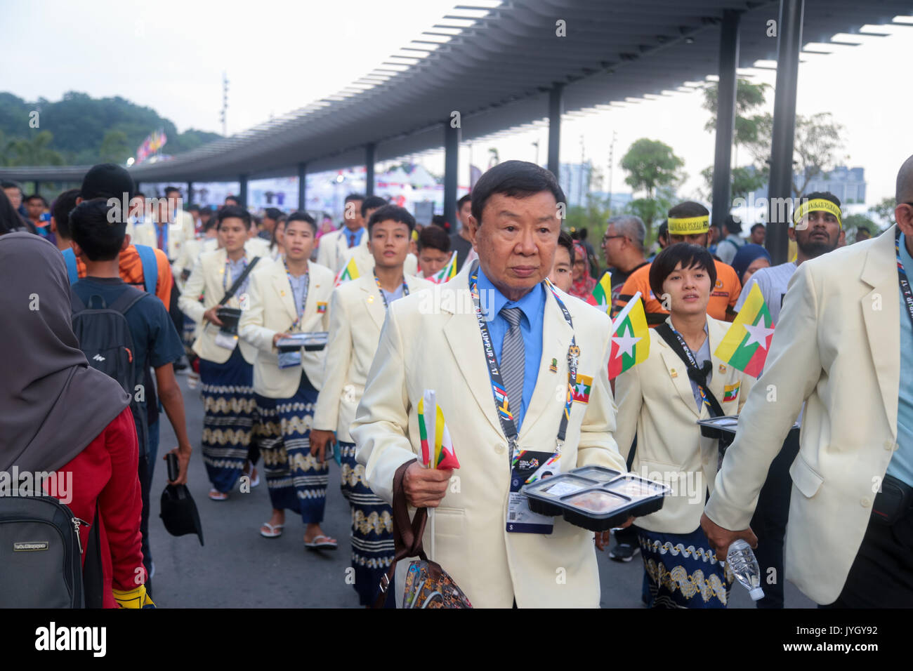 Myanmar officers group outside the national stadium during the opening ceremony of 29th SEA games. Credit: Calvin Chan/Alamy Live News Stock Photo
