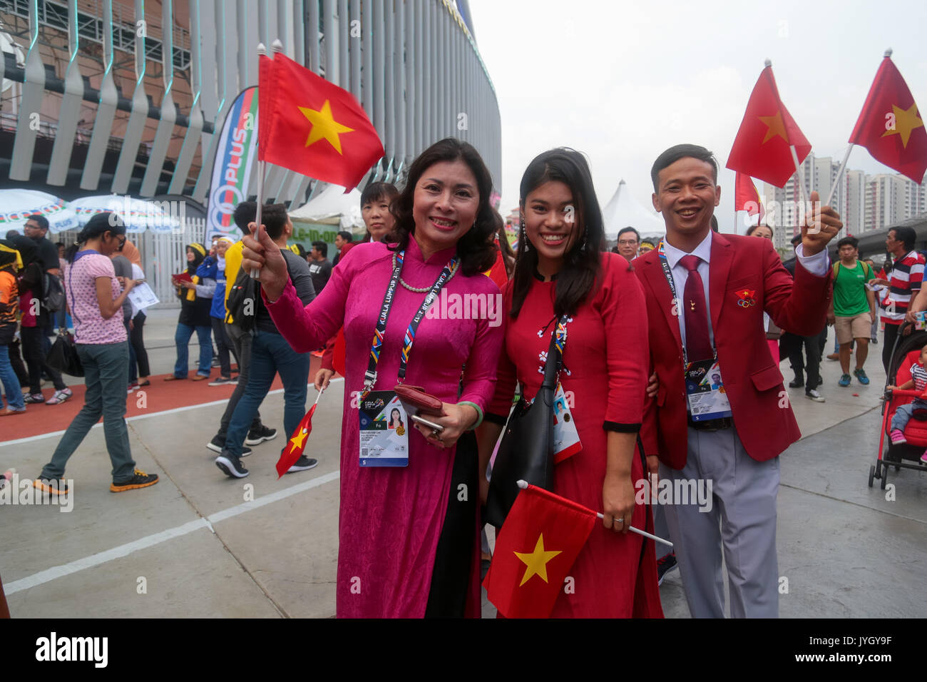Vietnam officer Nguyen Kim Lan and her colleague s outside the national stadium during the opening ceremony of 29th SEA games. Credit: Calvin Chan/Alamy Live News Stock Photo