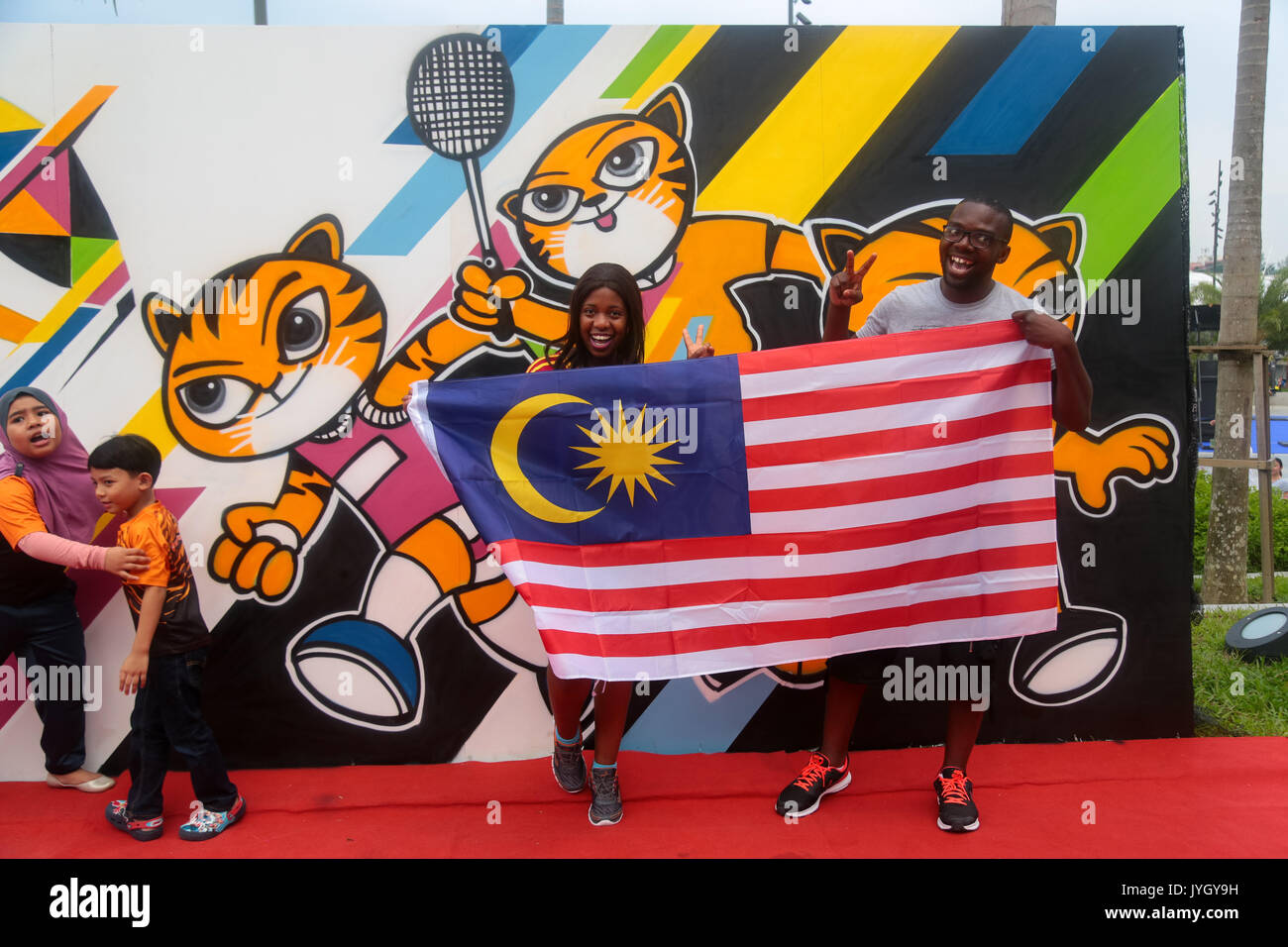 Foreigners taking picture with the official SEA games signboard during opening ceremony of the 29th SEA games. Credit: Calvin Chan/Alamy Live News Stock Photo