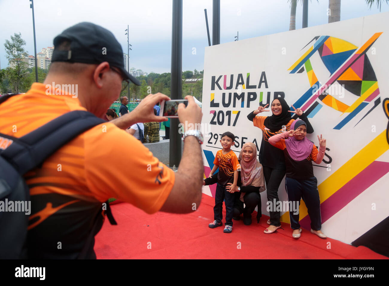 Malaysian family taking picture with the official SEA games signboard during opening ceremony of the 29th SEA games. Credit: Calvin Chan/Alamy Live News Stock Photo