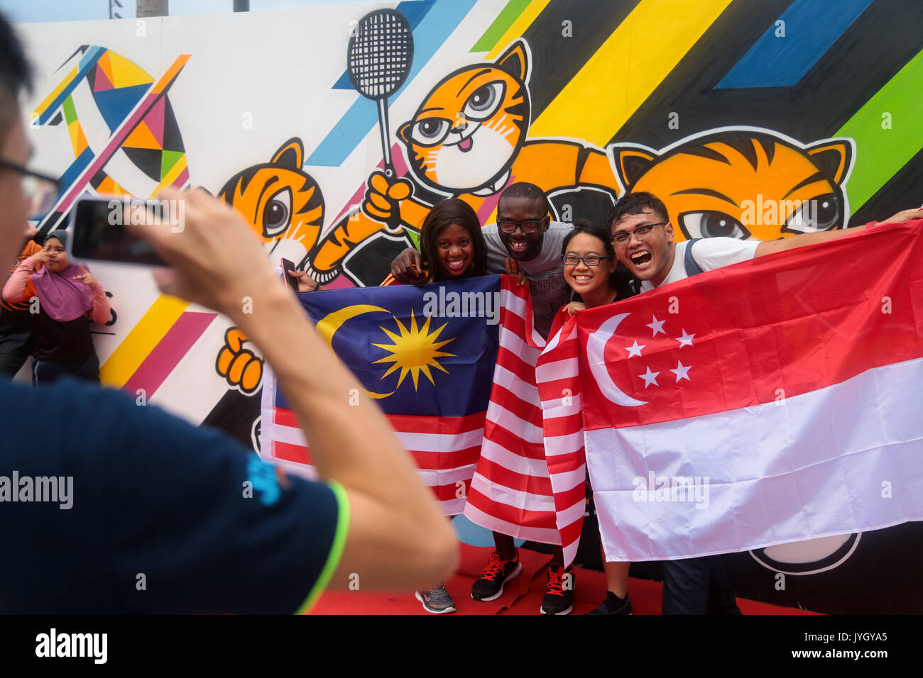Foreigners taking picture with the official SEA games signboard during opening ceremony of the 29th SEA games. Credit: Calvin Chan/Alamy Live News Stock Photo