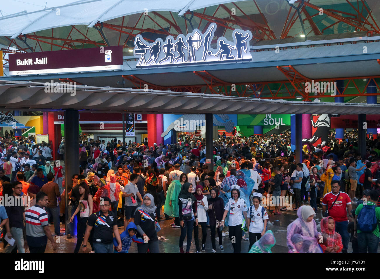 Spectator crowds attending the opening ceremony are outside the LRT statioin near national stadium during 29th SEA games. Credit: Calvin Chan/Alamy Live News Stock Photo