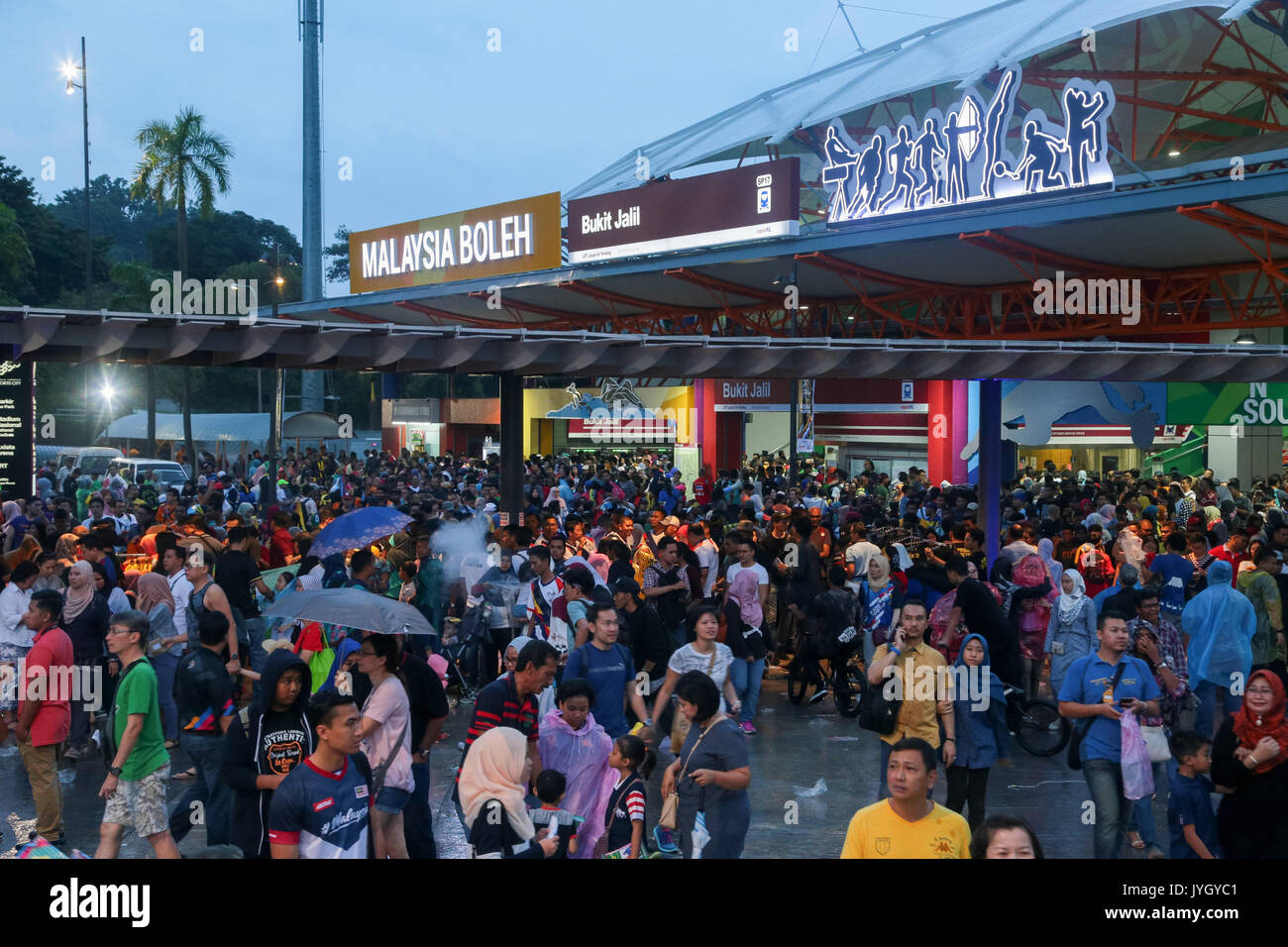 Spectator crowds attending the opening ceremony are outside the LRT statioin near national stadium during 29th SEA games. Credit: Calvin Chan/Alamy Live News Stock Photo
