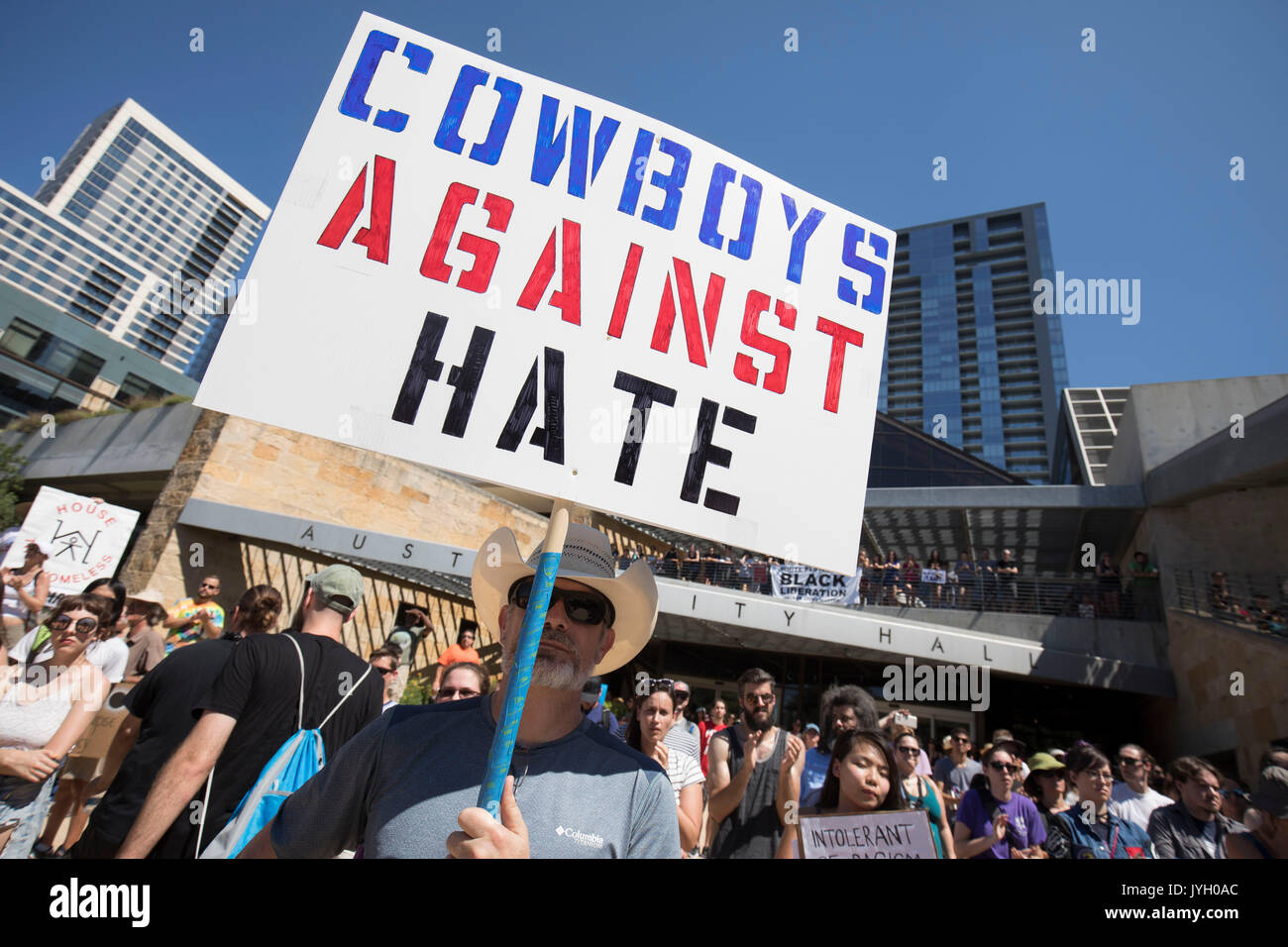 Activists and protesters converge on City Hall for a hot two-hour rally against racism and President Donald Trump's apparent insensitive comments about recent Charlottesville violence that left one dead. About 1,000 gathered in Saturday's Texas heat. Stock Photo
