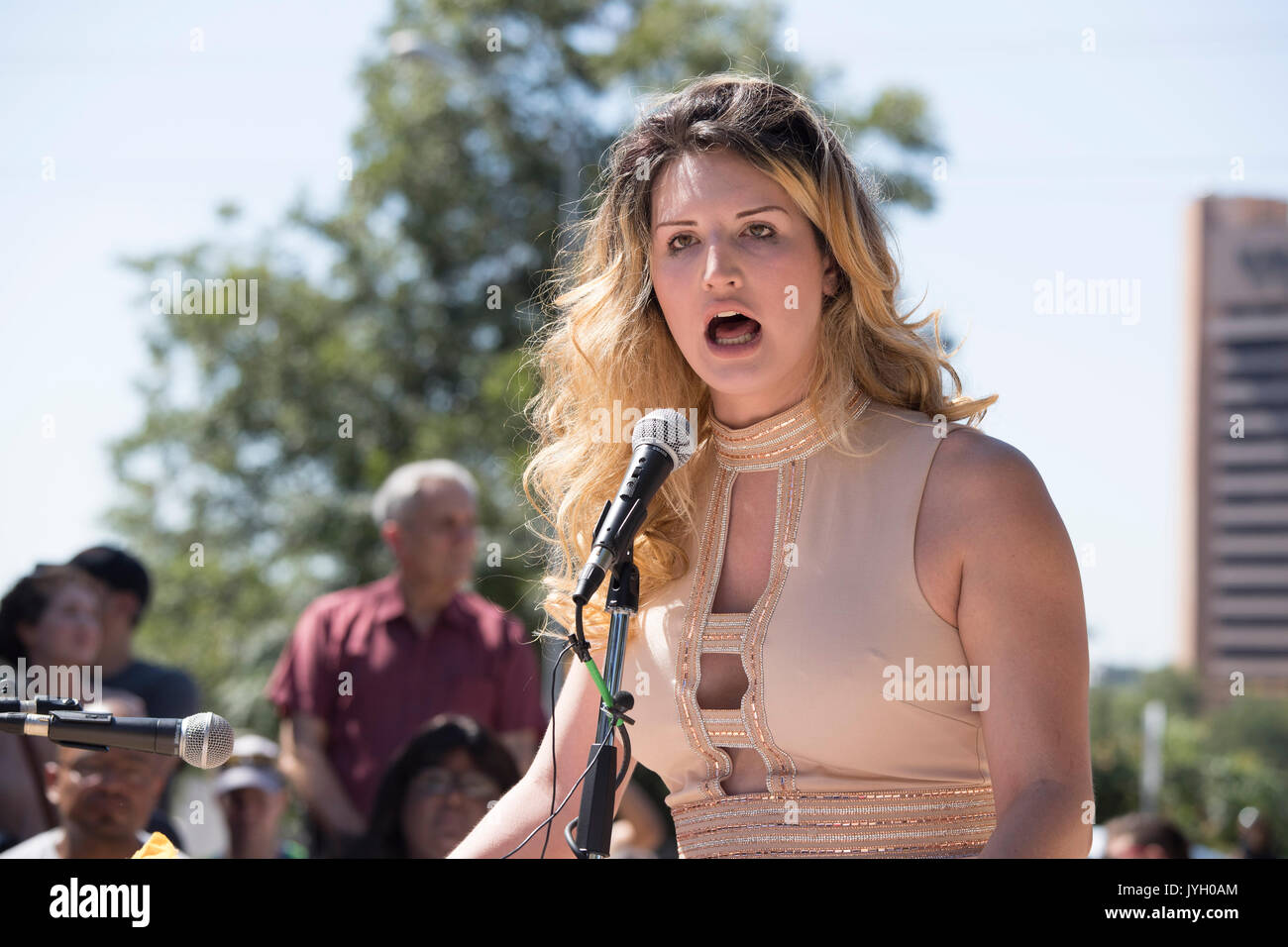 Transgender spokesperson Chrissie Foxx Paris speaks as activists and protesters converge on City Hall for a hot two-hour rally against racism and President Donald Trump's apparent insensitive comments about recent Charlottesville violence that left one dead. About 1,000 gathered in the August Texas heat. Stock Photo
