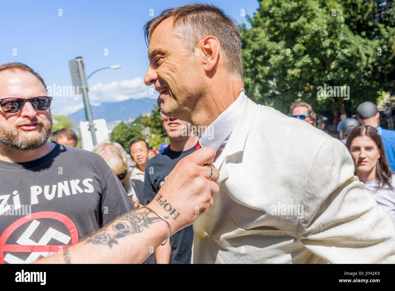 Vancouver, Canada. 19th Aug, 2017. Self professed nazi has nazi button ripped from jacket at Anti-Racism rally, City Hall, Vancouver, British Columbia, Canada. Credit: Michael Wheatley/Alamy Live News Stock Photo