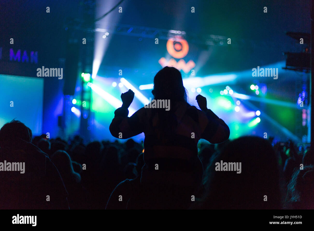 CROWD SCENE DANCING ON SHOULDERS IN SILHOUETTE: People dance wildly on one another's shoulders in silhouette in stage lighting as the crowd in the Far Out Tent during the LIARS set on Day Two of the Green Man music festival in Glanusk Park, Brecon, Wales on 19th August 2017. Credit: Rob Watkins/Alamy Live News Stock Photo